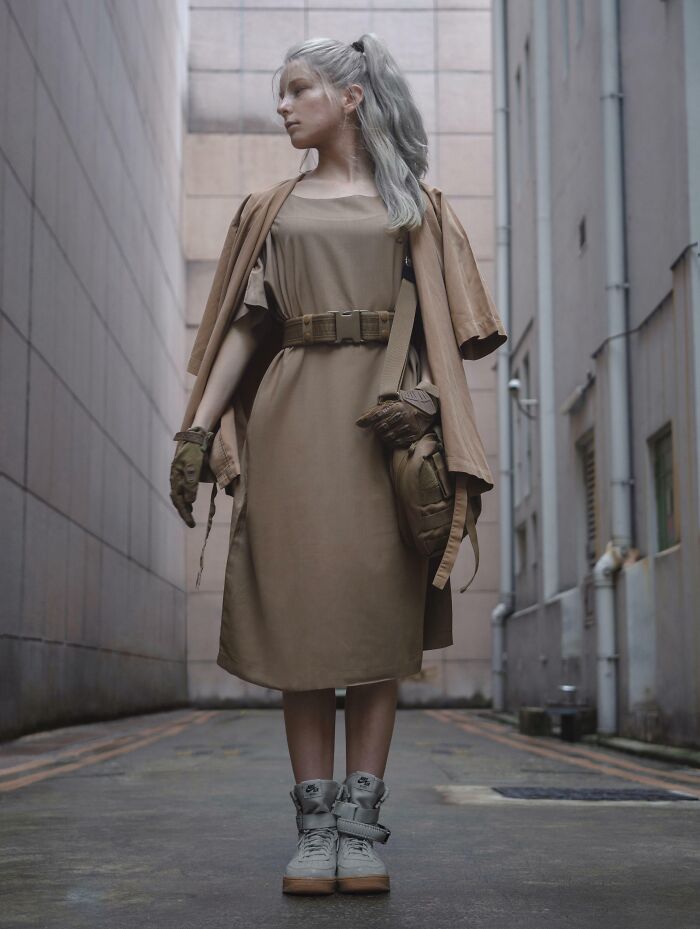 Fashion risk taken with a stylish monochromatic outfit, featuring a tan dress, gloves, and high-top sneakers in an urban setting.