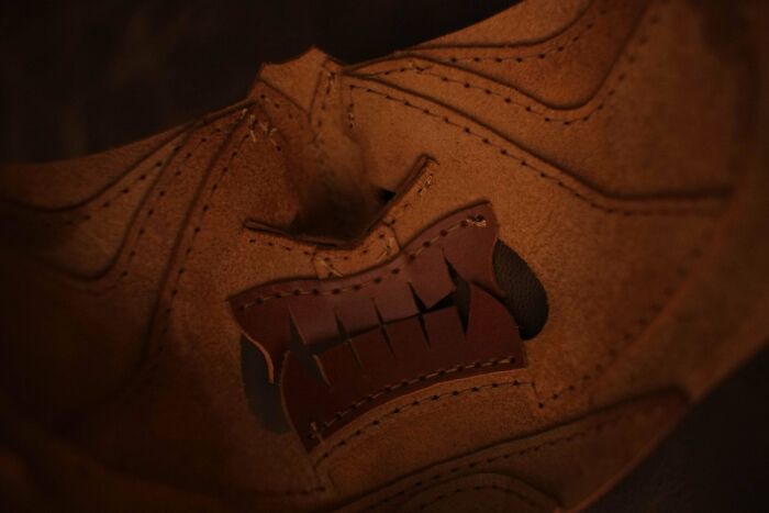 Leather DIY project with intricate stitching and carved details.