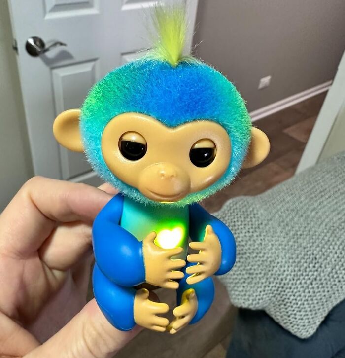 Toy monkey with blue fur and glowing heart, perfect gift for a fun aunt or uncle.