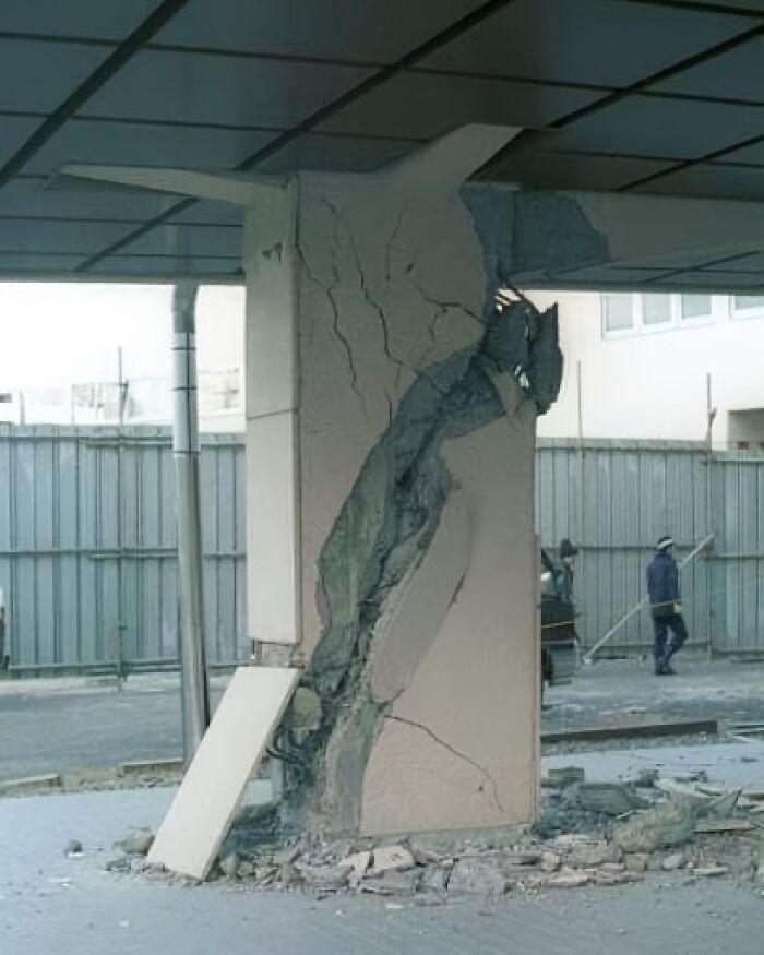 C*****d building column showing severe architecture fail with exposed damage.