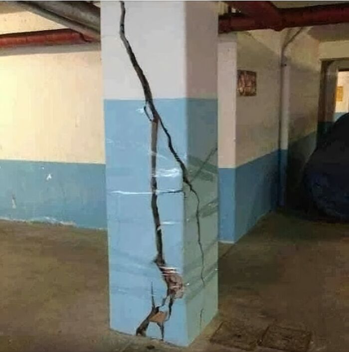 C*****d pillar in a basement showing architecture fails with significant structural damage.