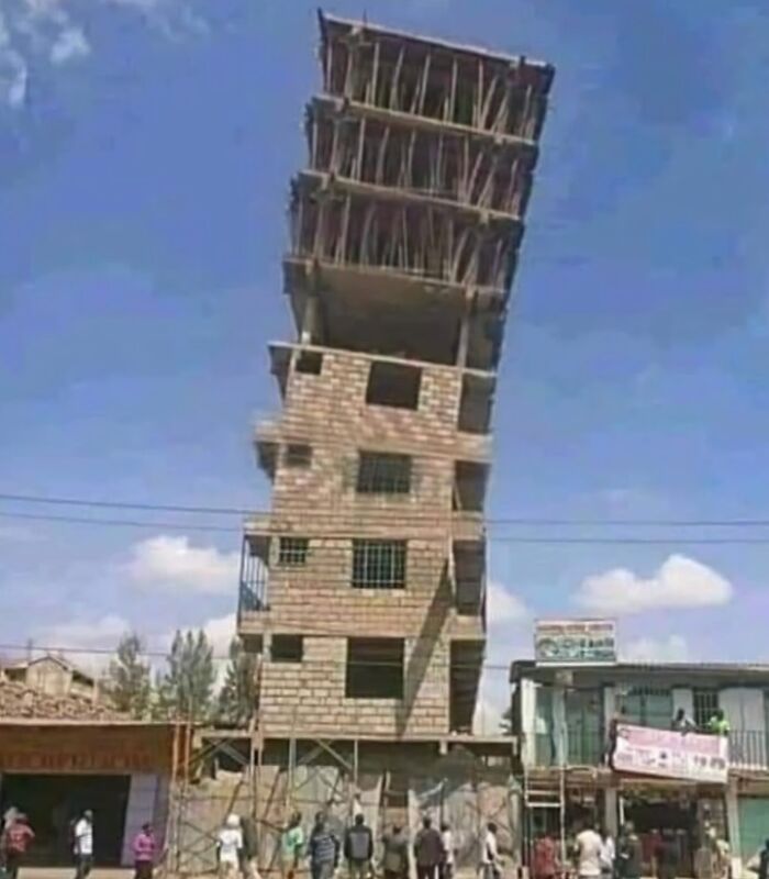 Leaning building under construction, illustrating an architecture fail with uneven floors against a blue sky backdrop.