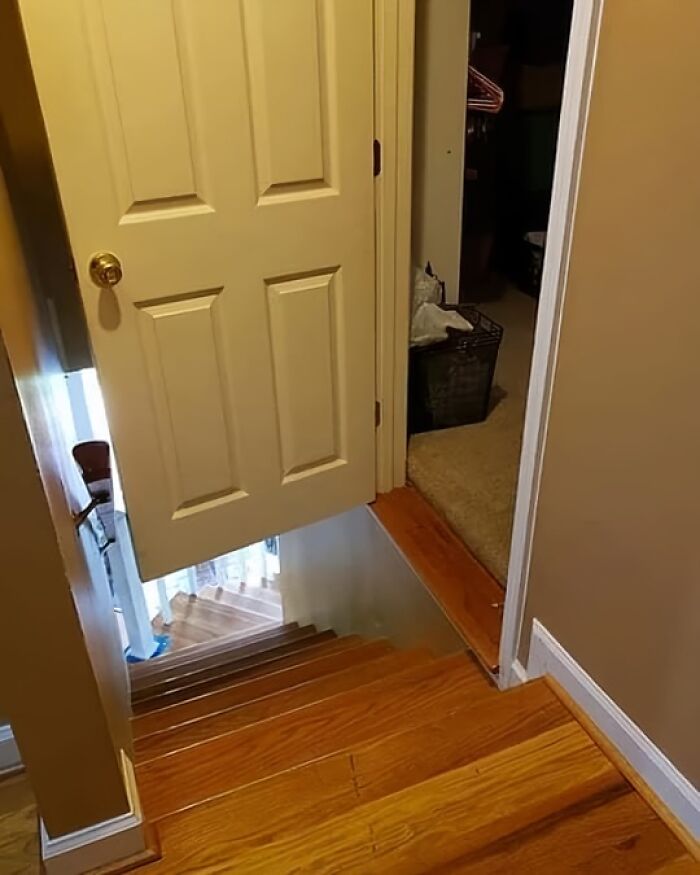 Misaligned door opens directly onto a stairway, showcasing an architecture fail.