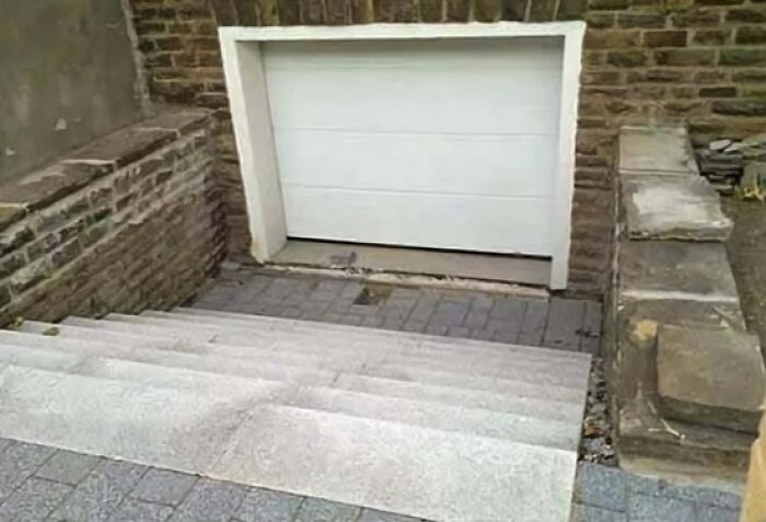 Staircase leading to a garage door, showcasing an architecture fail.
