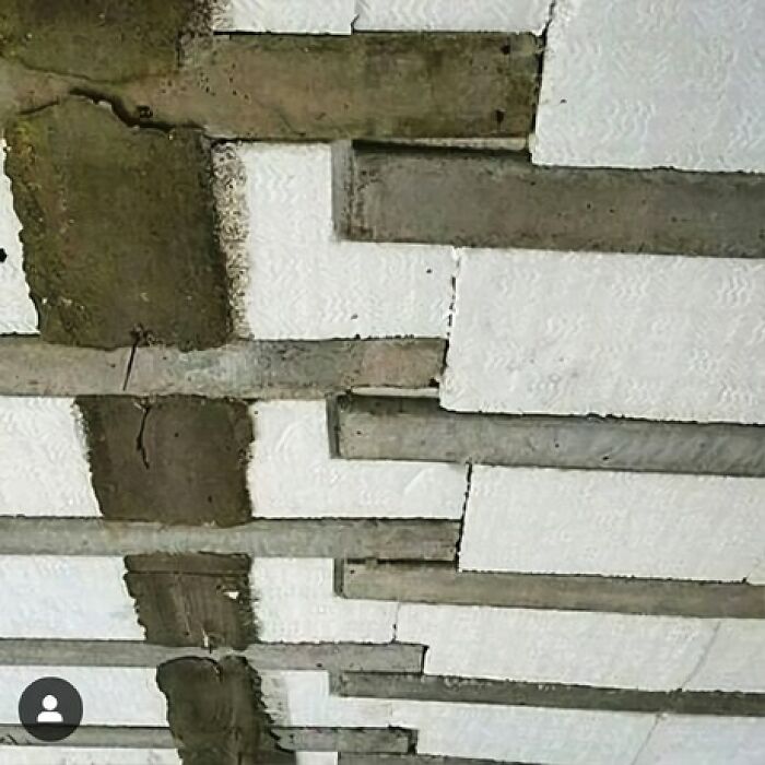 C*****d ceiling showing an architecture fail with uneven beams and visible concrete issues.