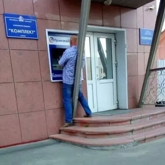 A design fail with a pillar blocking access to an ATM, showing poor design judgment.