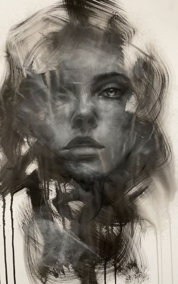 Charcoal portrait by Josh Hernandez, showcasing an expressive face with blurred, dynamic strokes.