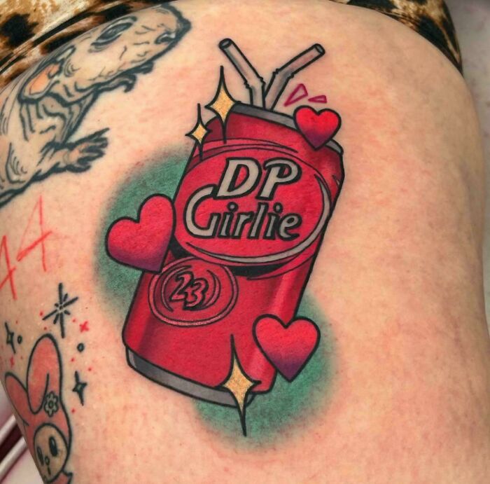 Colorful tattoo of a red soda can with hearts and straws, showing a funny example of awful taste but great e*******n.