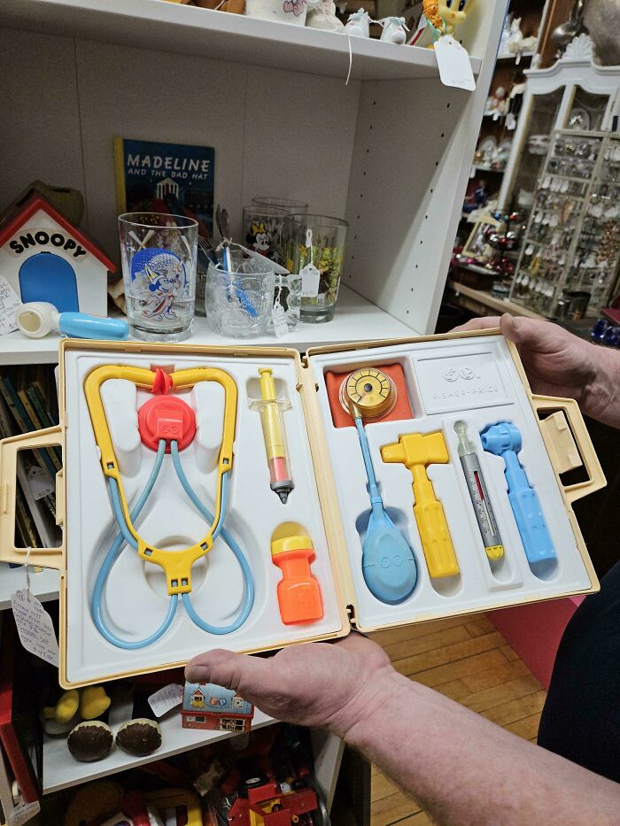 Vintage toy doctor set in a case, displayed in an antique shop.