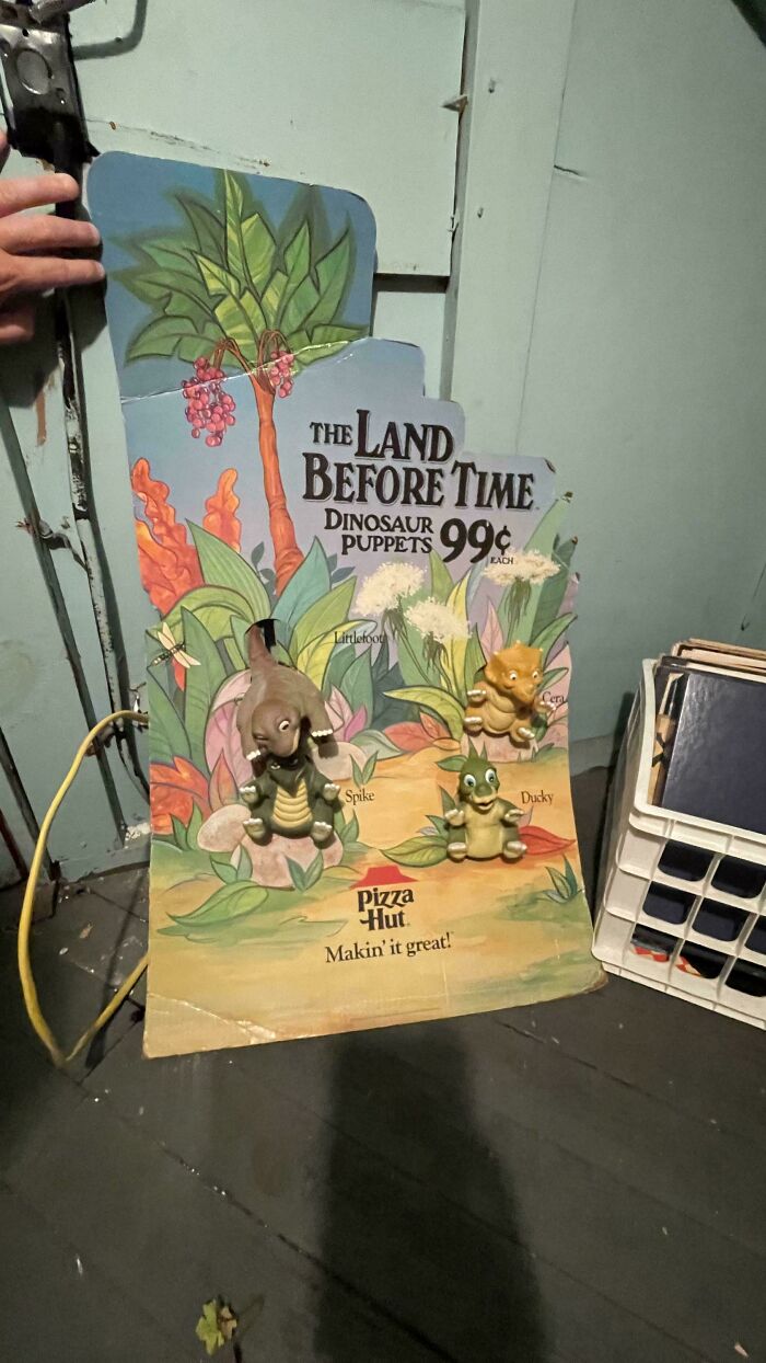 Vintage toys display featuring The Land Before Time dinosaur puppets from Pizza Hut, evoking childhood memories.