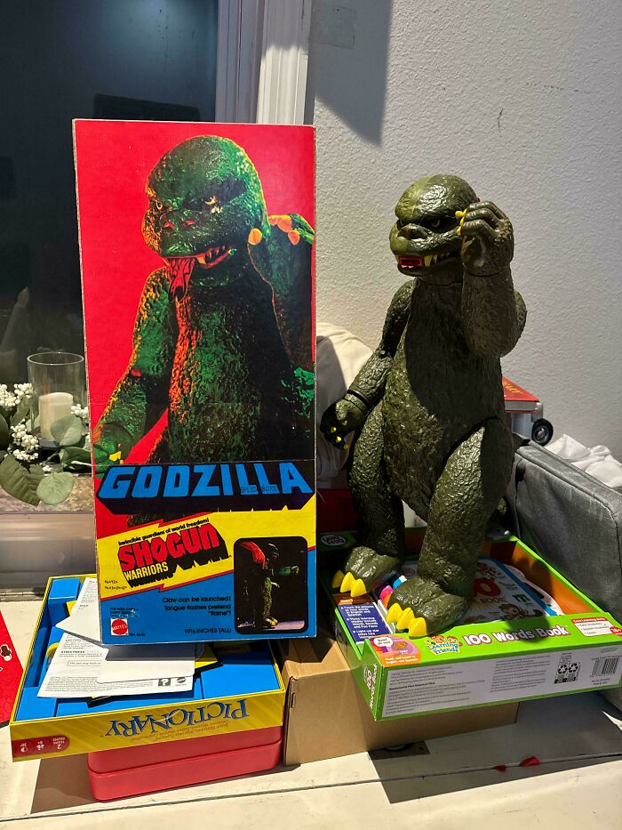 Vintage toys featuring a Shogun Warriors Godzilla figure and box on display.