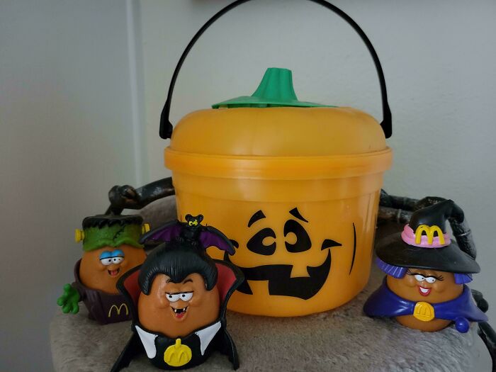 Vintage toys featuring Halloween-themed McDonald's Happy Meal figures with a pumpkin container.