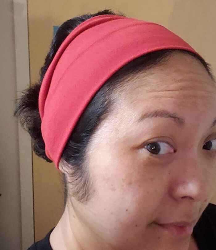 Person using a classic beauty hack with a red headband, showcasing old school beauty techniques.