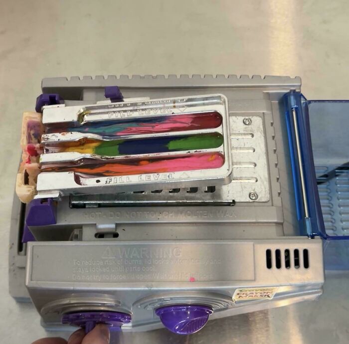 Vintage toy in silver with colorful compartments and purple knobs, evoking nostalgia and childhood memories.