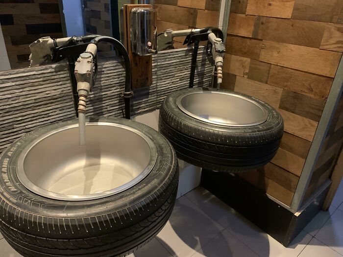 Sinks made from tires with taps, showcasing tourist-interesting-experiences in a creative restroom design.