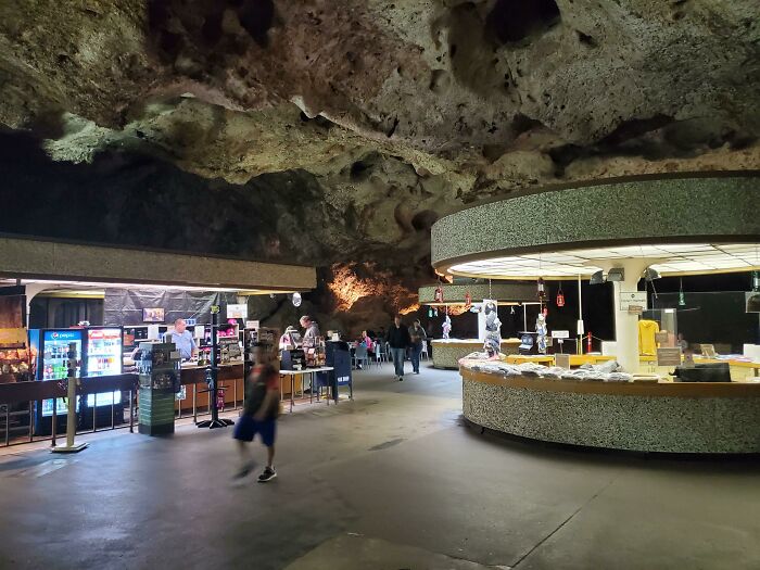 Cave dining area with tourists exploring interesting experiences underground.
