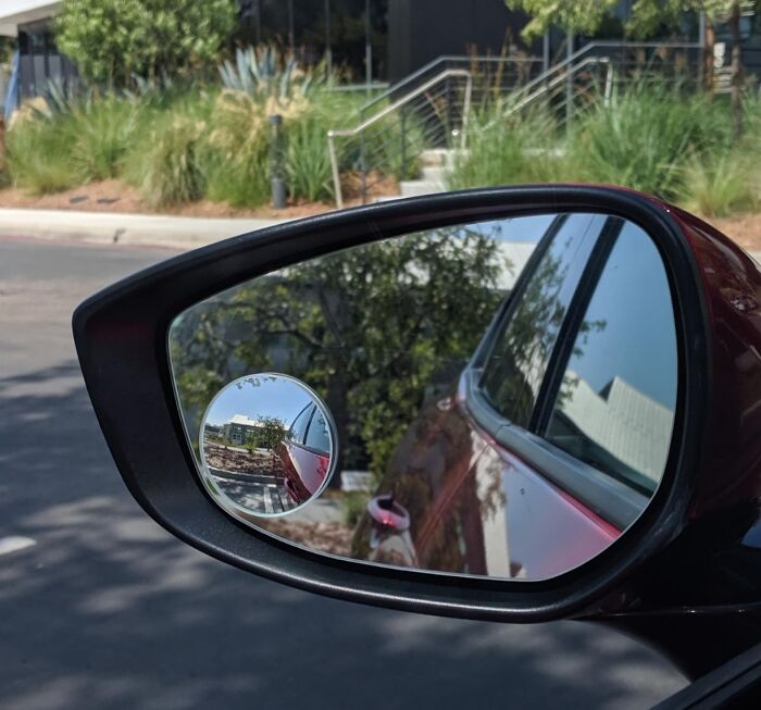 Car side mirror with an additional convex mirror, a clever invention to reduce blind spots and frustration while driving.