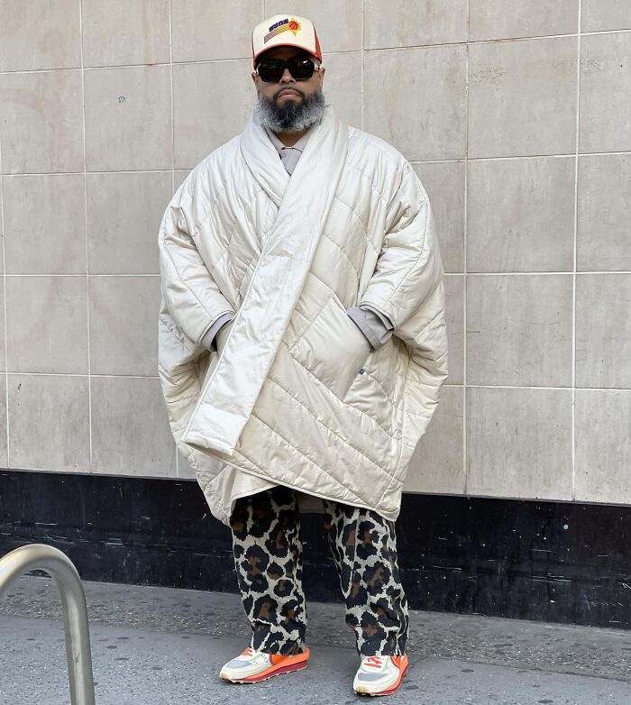A person showcases bold fashion risks with an oversized quilted coat and leopard print pants.