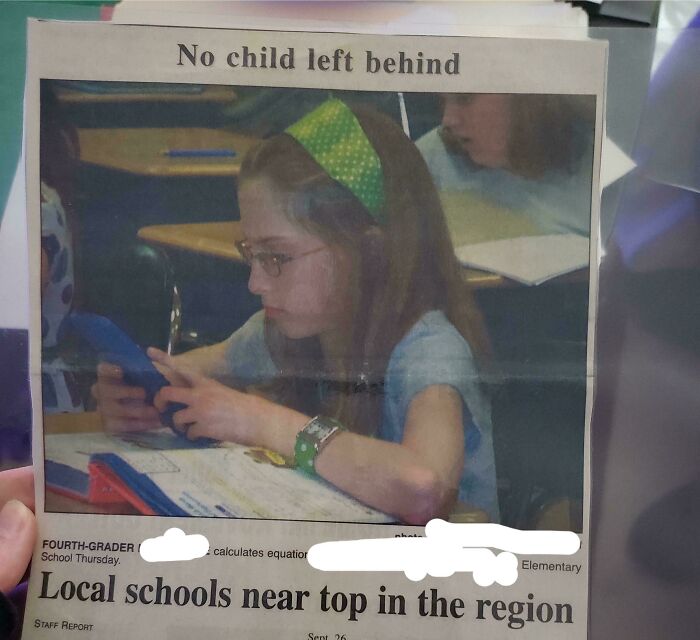 Child in school photo focusing on calculator, a nostalgic glimpse from people’s regrettable past cringe-worthy moments.