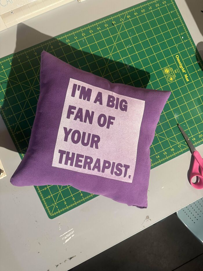 Purple DIY pillow with text "I'M A BIG FAN OF YOUR THERAPIST" on a crafting table.