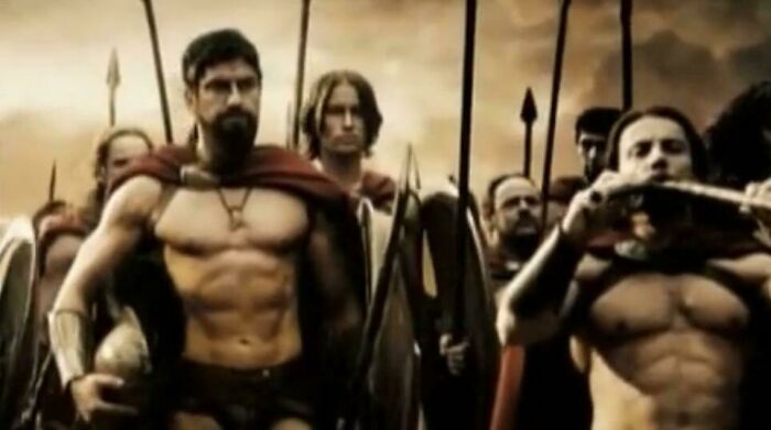 A group of muscular warriors in ancient armor holding spears, showcasing questionable movie details mocked by cinephiles online.
