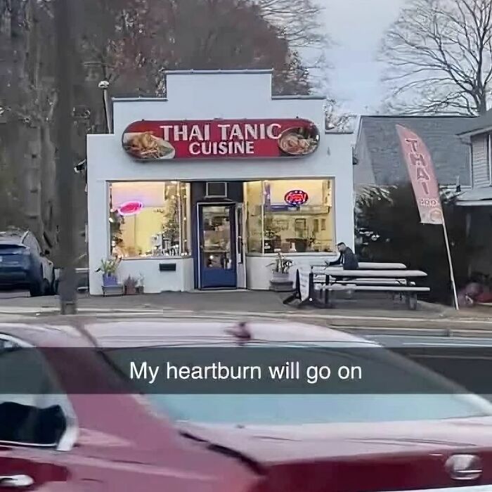 Thai restaurant sign humorously reads "Thai Tanic Cuisine," referencing men's humor memes.