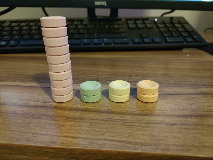Colorful stacks of round candies on a wooden desk, illustrating interesting charts creatively.