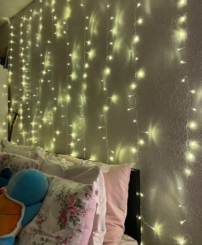 Fairy lights illuminating a bedroom wall, transforming the space with a cozy and magical ambiance.
