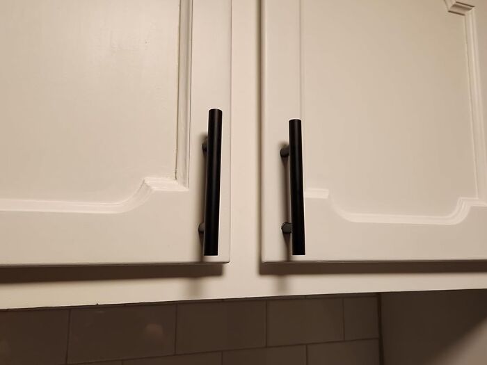 White cabinet doors with black handles, showcasing a simple way to transform things you already own.