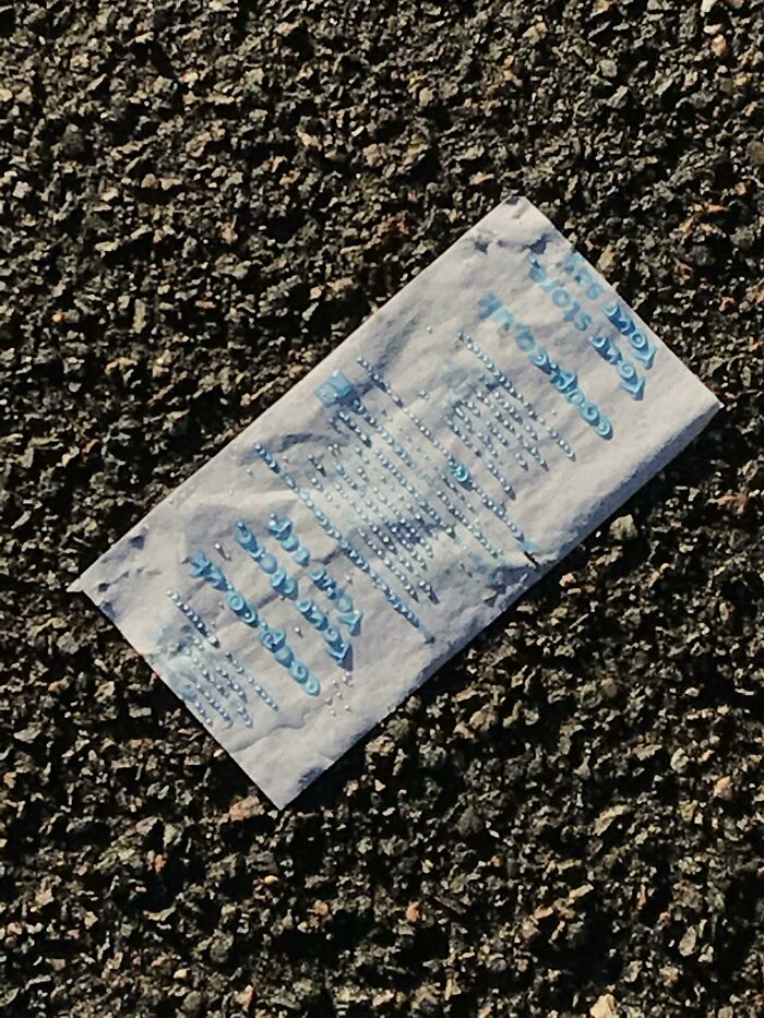 A weathered receipt on asphalt with blue text, capturing the essence of interesting receipts people have found.