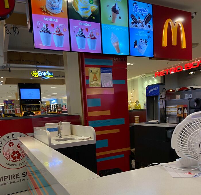McDonald's ice cream counter in a shopping mall, showcasing tourist-interesting-experiences with vibrant menu displays.