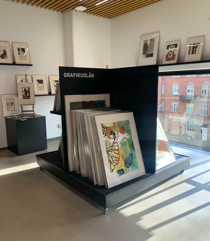 Gallery interior featuring framed art displays by a window, an interesting tourist experience.