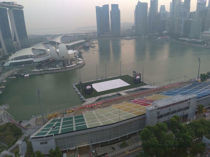 Aerial view of a waterfront cityscape, showcasing tourist-interesting experiences with iconic architecture and skyline.