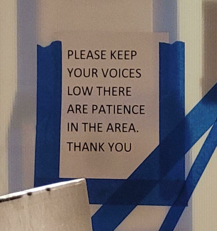 Sign with a humorous spelling error taped to a wall, illustrating ridiculous word spellings that make grammar police cringe.