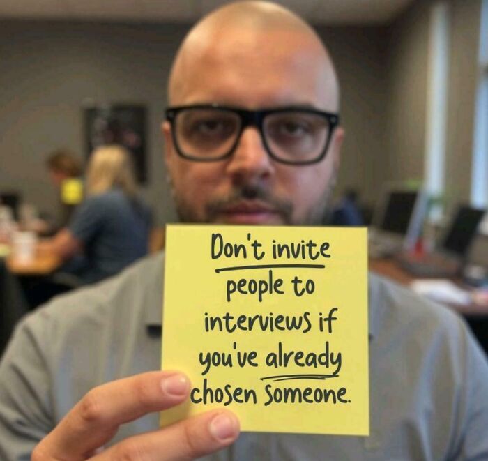 Person holding a sticky note with a message on recruiting mistakes in an office setting, highlighting "Recruiting Hell" issues.