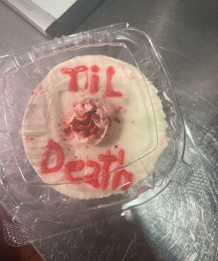 Cake with "Til Death" written in red icing, possibly symbolizing infuriating cancelled reservations scenario.