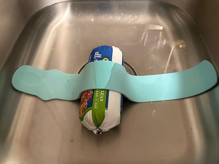 Clever invention for evenly thawing frozen meat in a sink using a spreader.