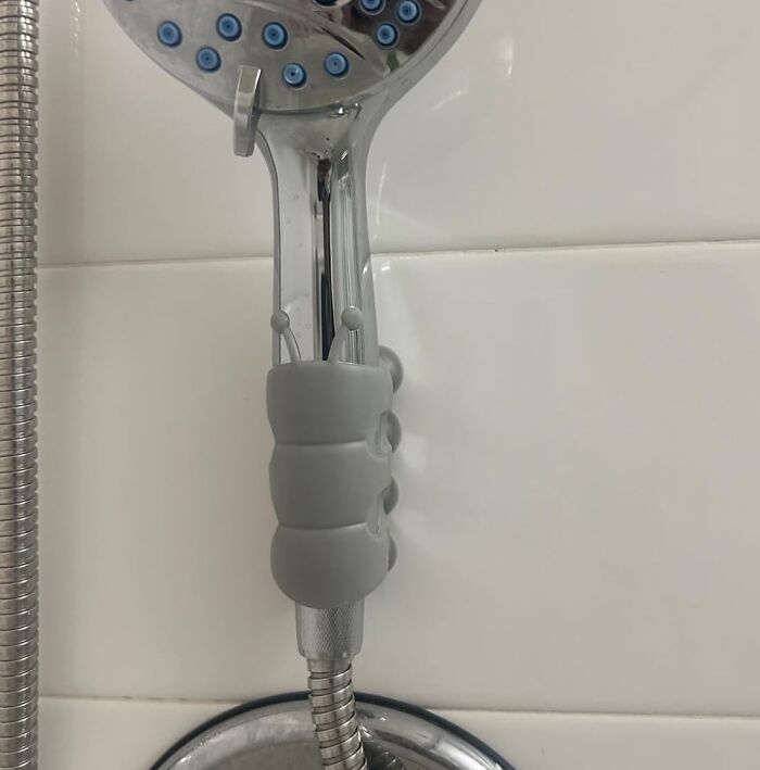 Showerhead with ergonomic gray grip, highlighting a clever invention for better handling.