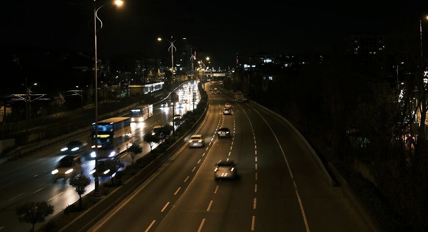 Nighttime city highway scene illustrating ethical dilemmas in driving decisions.