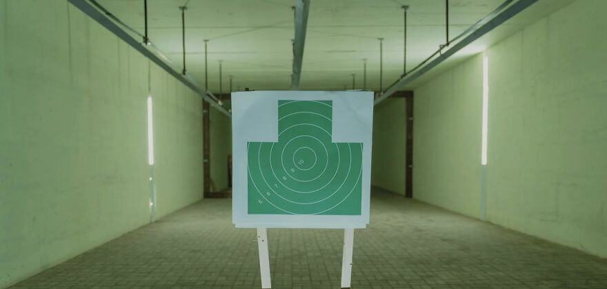 Target board in an empty room, illustrating ethical dilemmas and decisions.