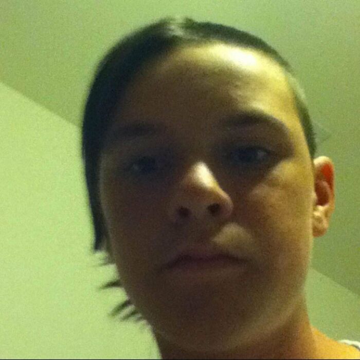 Close-up selfie of a young person with an awkward hairstyle, representing a regrettable past photo from people's cringe-worthy moments.