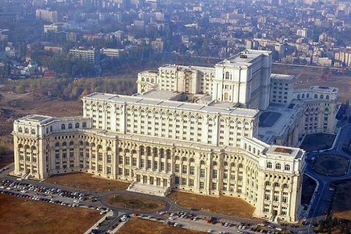 Massive neoclassical building with imposing architecture, resembling evil aura buildings fit for supervillain headquarters.