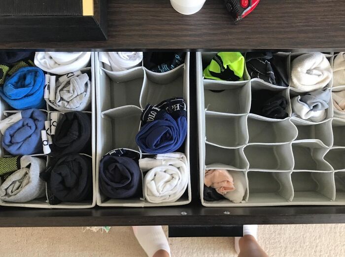 Organized drawer with rolled socks, a perfect spring cleaning headstart for tidy storage solutions.