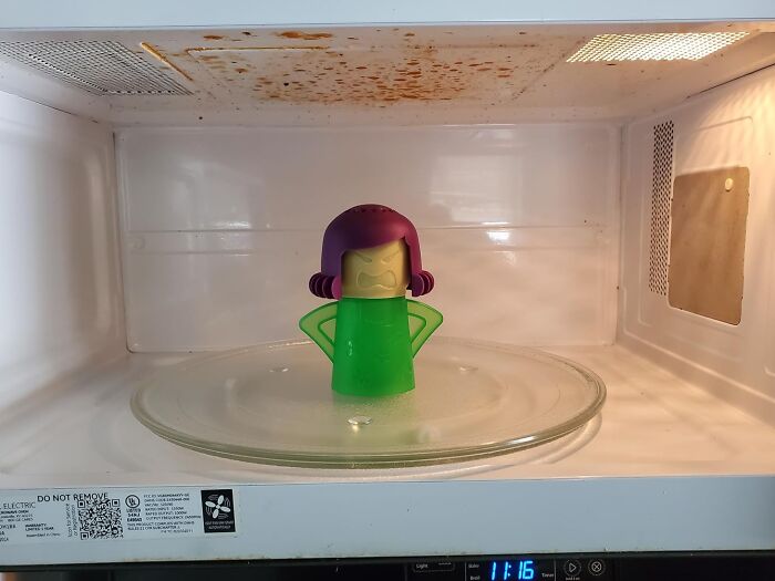 A microwave cleaner device inside a dirty microwave, symbolizing a spring cleaning headstart.