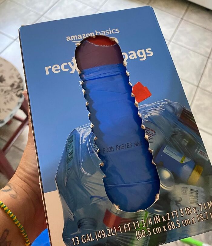 Box of AmazonBasics recycling bags for spring cleaning headstart, showing a hand pulling a blue bag through a cutout.