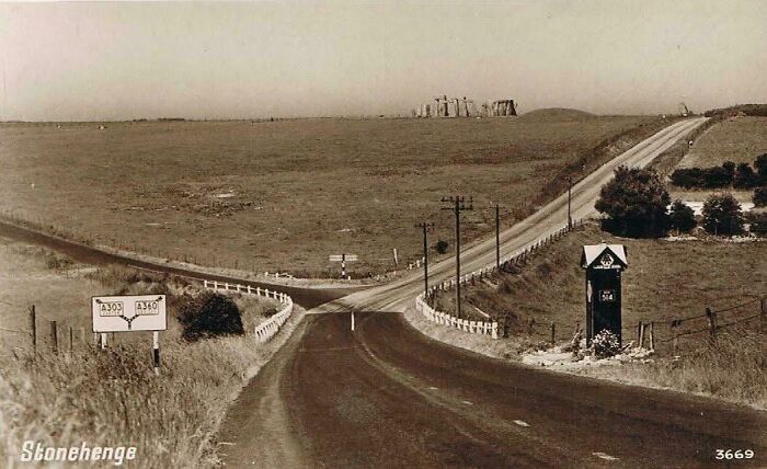 Vintage view of Stonehenge from a distant road intersection, showcasing the landmark's new perspective.