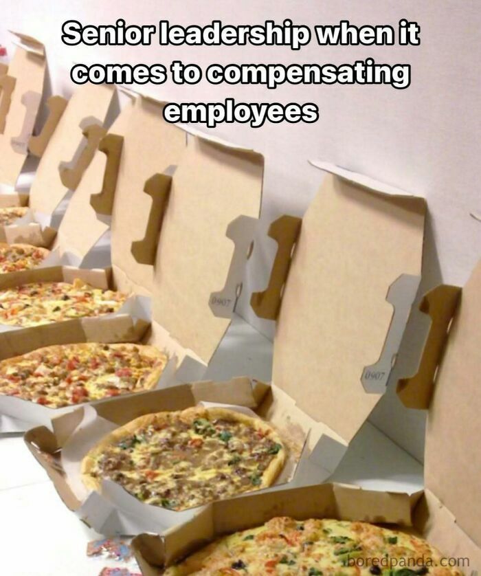 Pizza boxes with meme text: "Senior leadership when it comes to compensating employees," highlighting relatable humor.