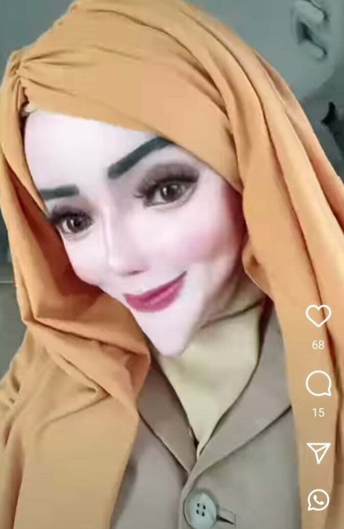 Person with exaggerated airbrush effects on face, creating a surreal appearance, wearing an orange hijab.