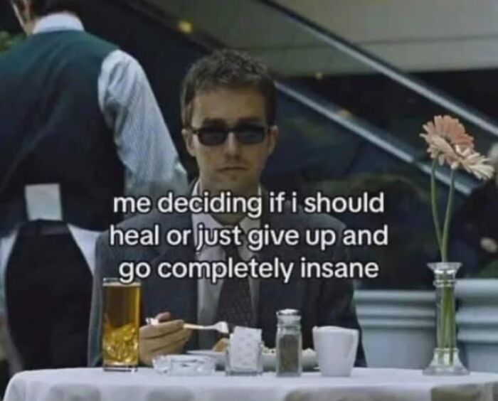 Person with sunglasses at a cafe, contemplating life choices. Text overlay references mental health memes.