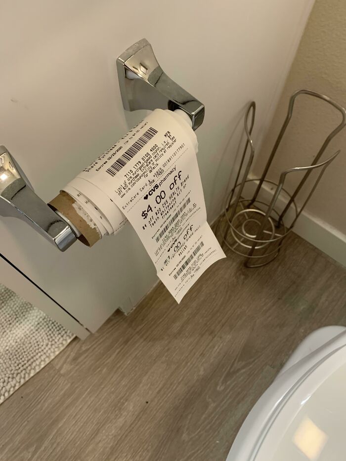 Receipt used as toilet paper in a bathroom, showcasing interesting finds.